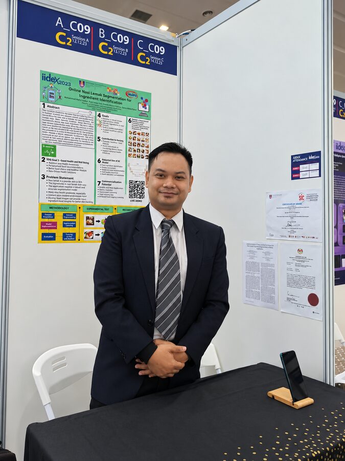 Mohammad Hafiz bin Ismail at an exhibition booth during a public event
